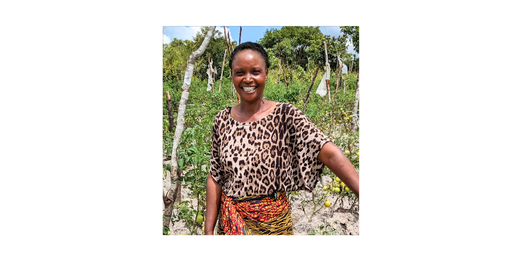 Brenda, a single mother, stands in her tomato patch