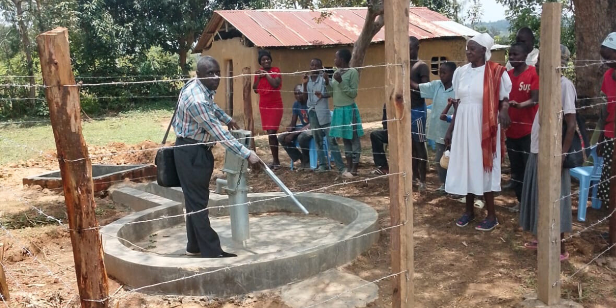 People stand outside a well at a Nazarene church in Kenya