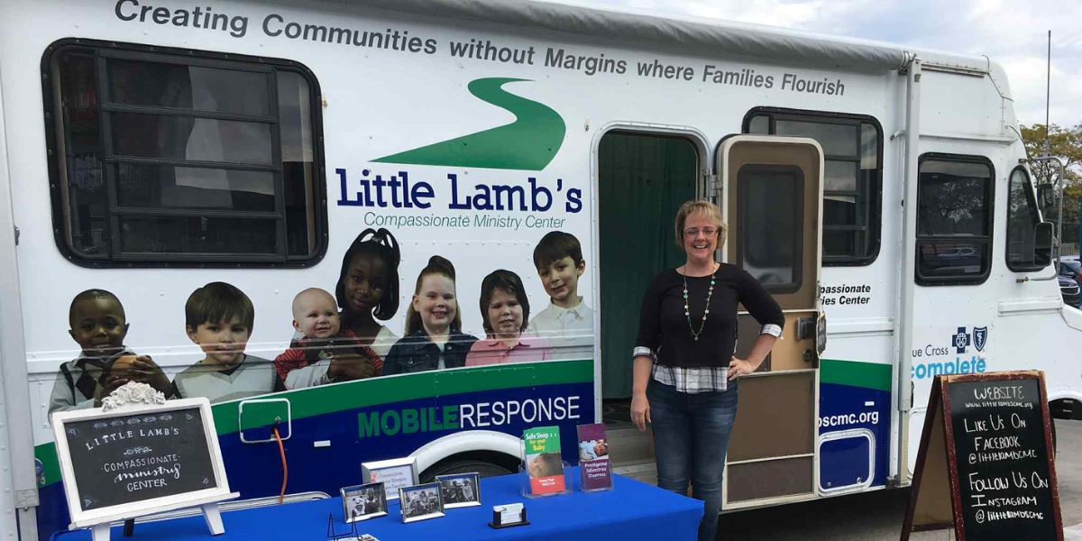 Dawn Ramirez, center director, standing in front of Little Lamb's van