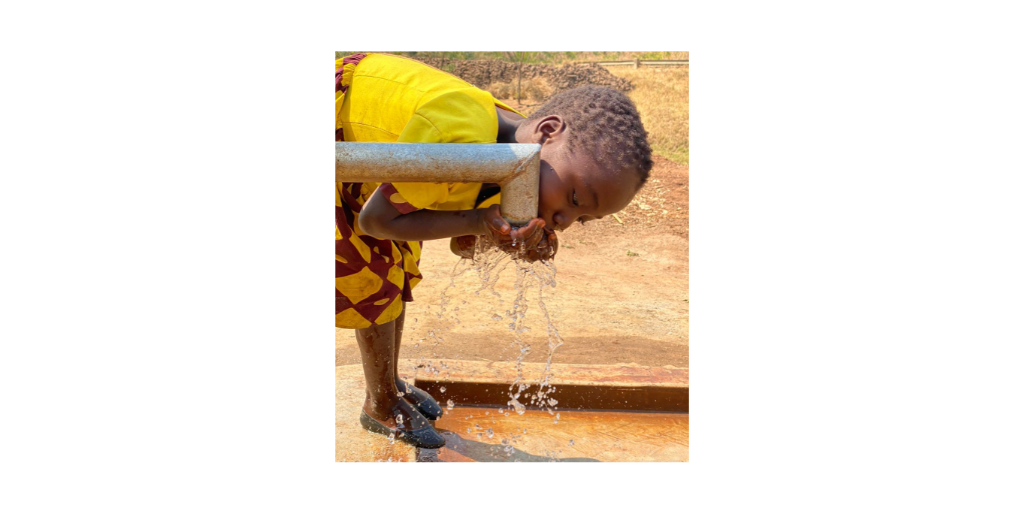 child drinking from well