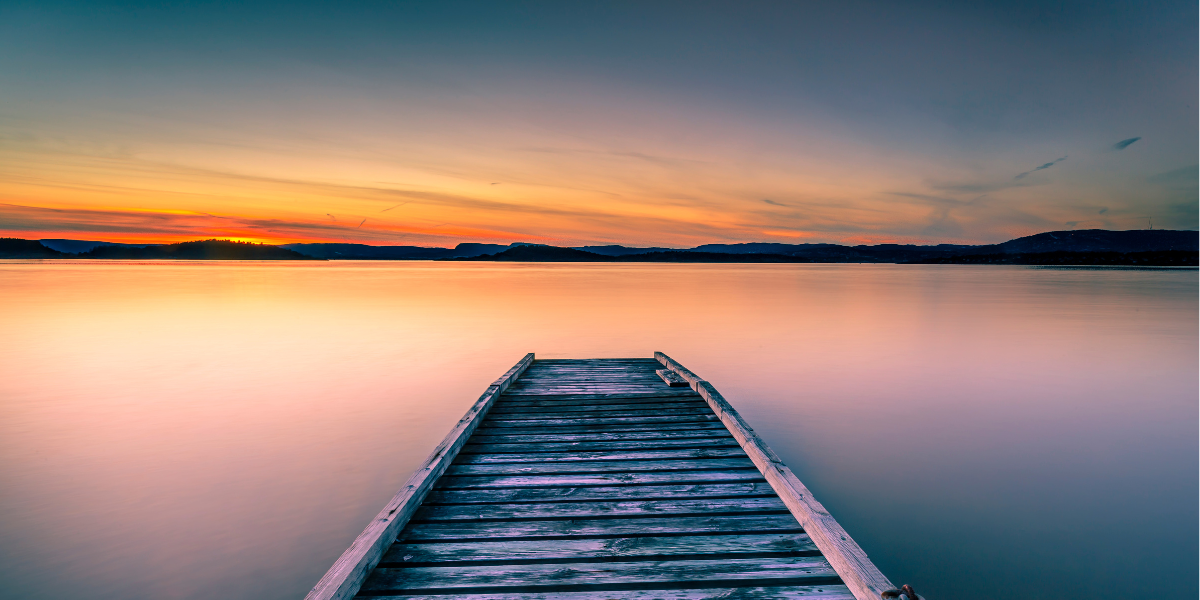 Peaceful scene on a lake with a setting sun 
