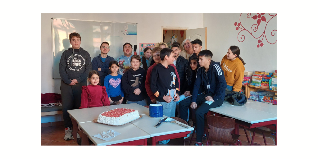 Romanian children gathered around a birthday cake