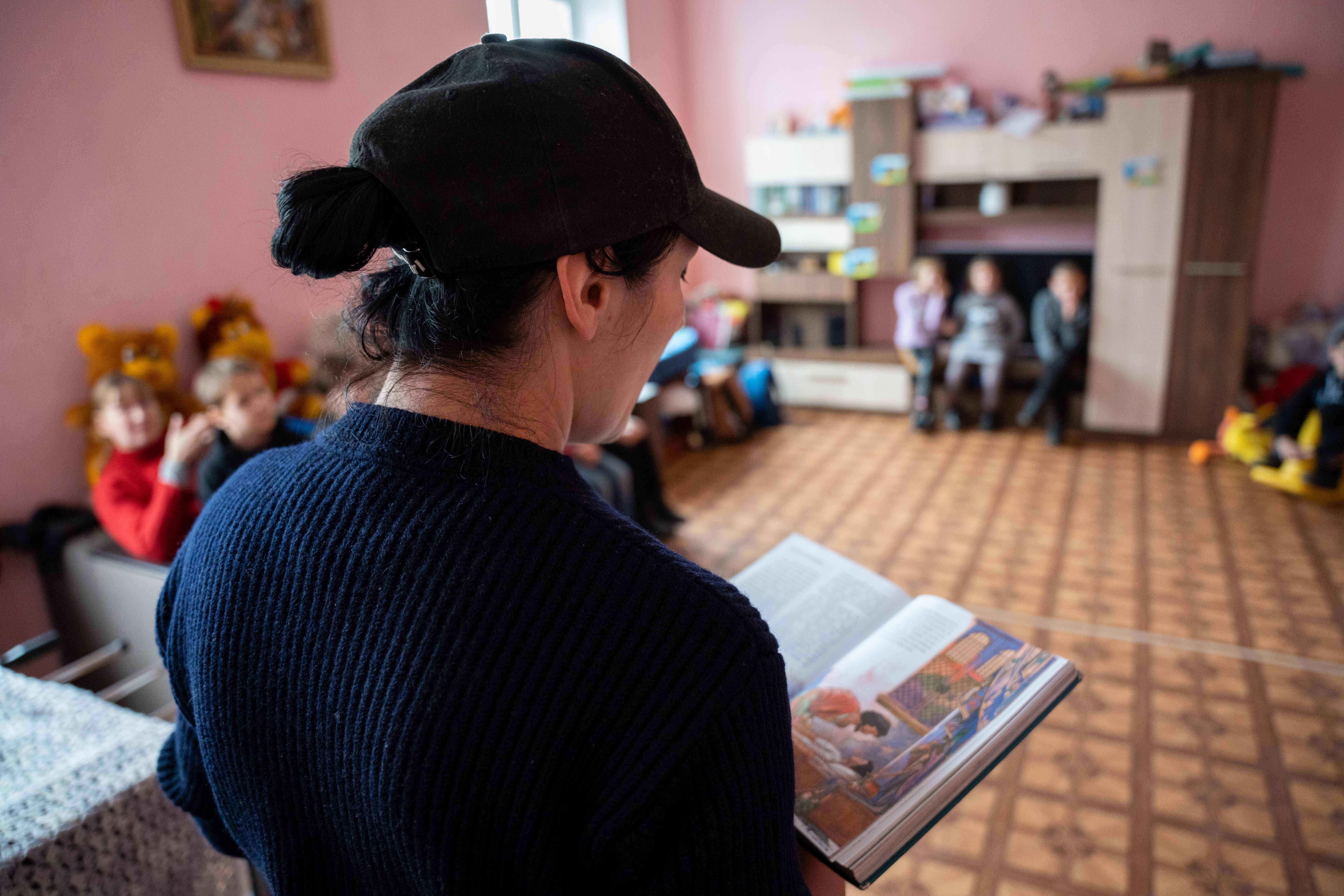 Woman reading to children