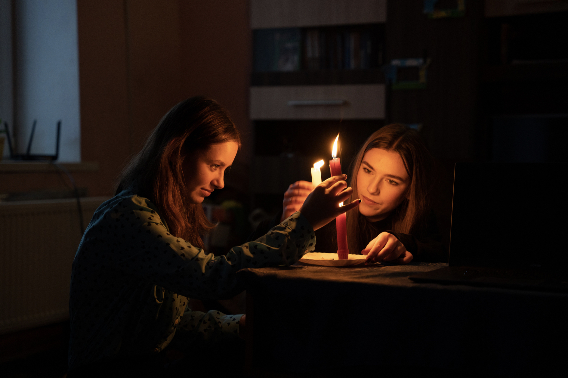 two teenagers lighting advent candles