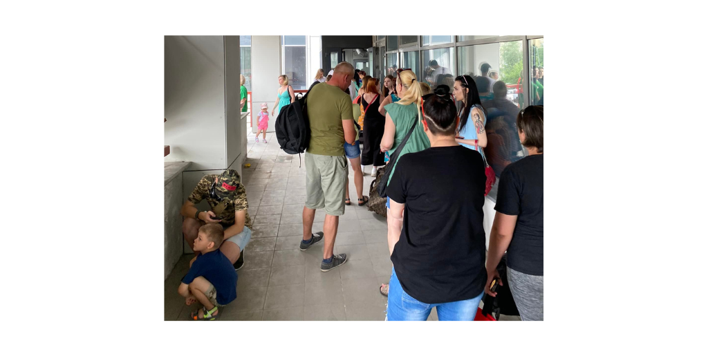 people stand in line for food in Ukraine