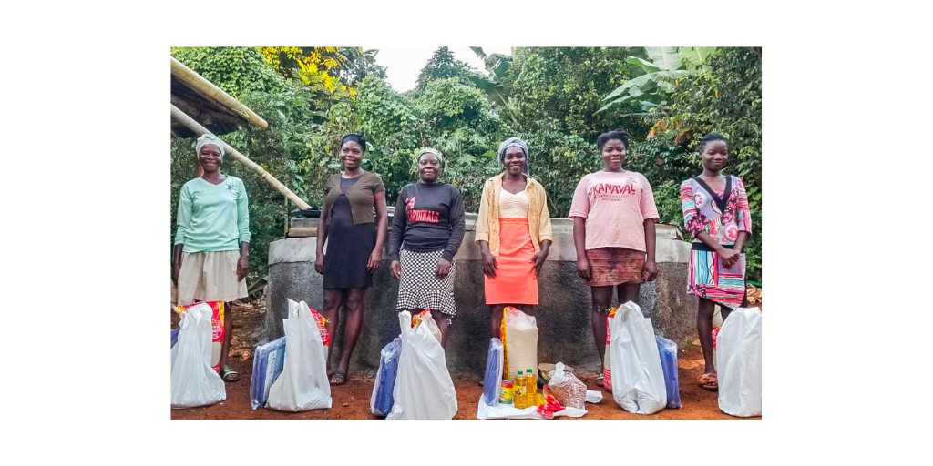 women in Haiti receiving bags of food