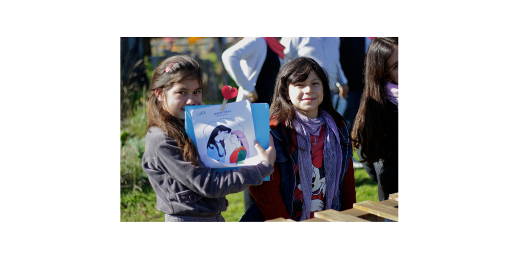 girls holding drawing