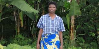 Mukashyaka standing in her garden