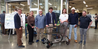 Students standing with adapted shopping cart
