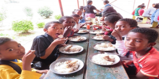 Children share a meal at the Madagascar Street Kids Center, where regular, nutritious meals help them grow stronger and stay active.
